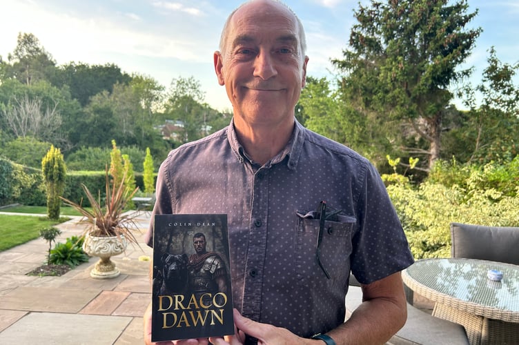 Colin Dean with his book Draco Dawn, The Street, Dockenfield, August 20th 2025.