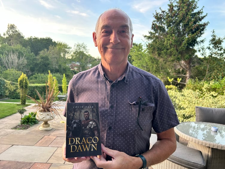 Colin Dean with his book Draco Dawn, The Street, Dockenfield, August 20th 2025.