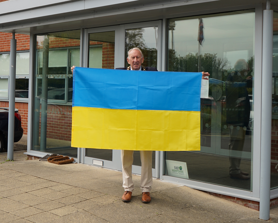 <p>Cllr Graham Hill with the flag of Ukraine.</p>