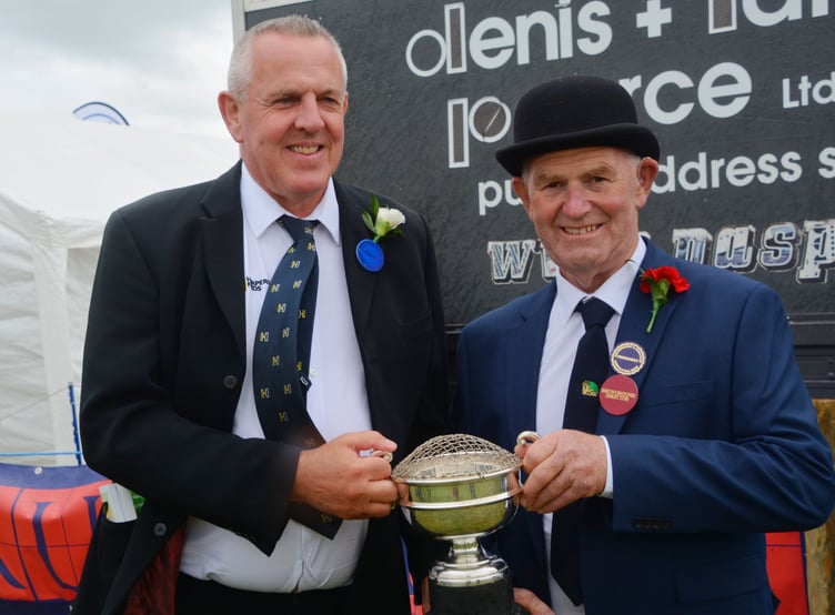 Glen Johns from Massey Harpers receiving the cup from Holsworthy and Stratton Agricultural Show president Martyn Mill. (Picture: Rodney Parrish)