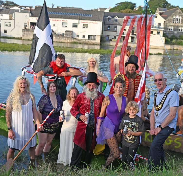 Taking the trophy for best dressed in the raft race from Wadebridge Town mayor Cllr Ian Welch are Keith Briskham and Family with the Greatest Showman (Picture: Adrian Jasper)