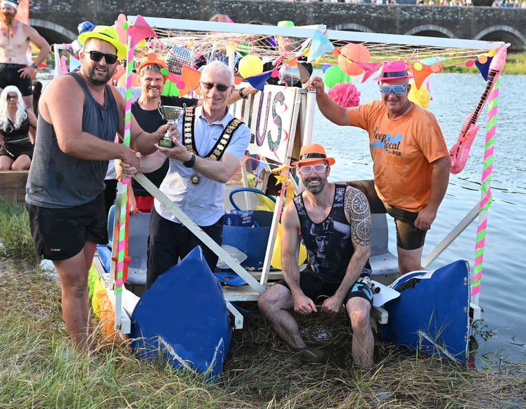Receiving the winners trophy from the Wadebridge Town Mayor Cllr Ian Welch are the Friends of Washaway and surrounding area with their raft The Neon Nautilus (Picture: Adrian Jasper)