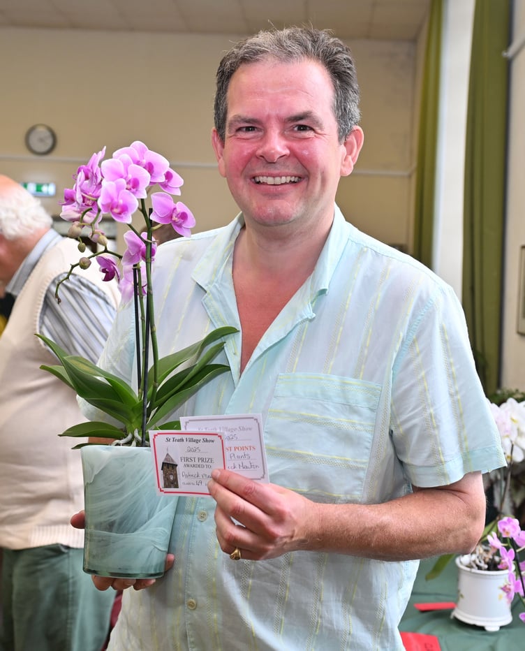 A delighted Patrick Mewton takes first prize with his Orchid in flower along with most points in the Pot Plant class section of the show (Picture: Adrian Jasper)