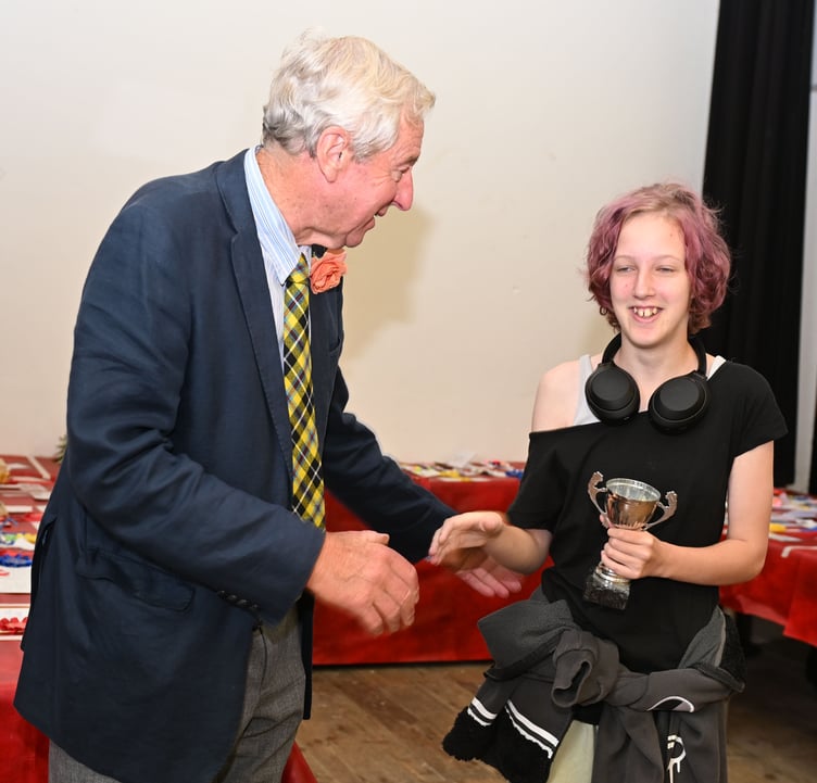 First time entering the show is Raine of the Acrewood Project who takes her trophy from show president Gerald Blewett for best Art Exhibit under 16 (Picture: Adrian Jasper)