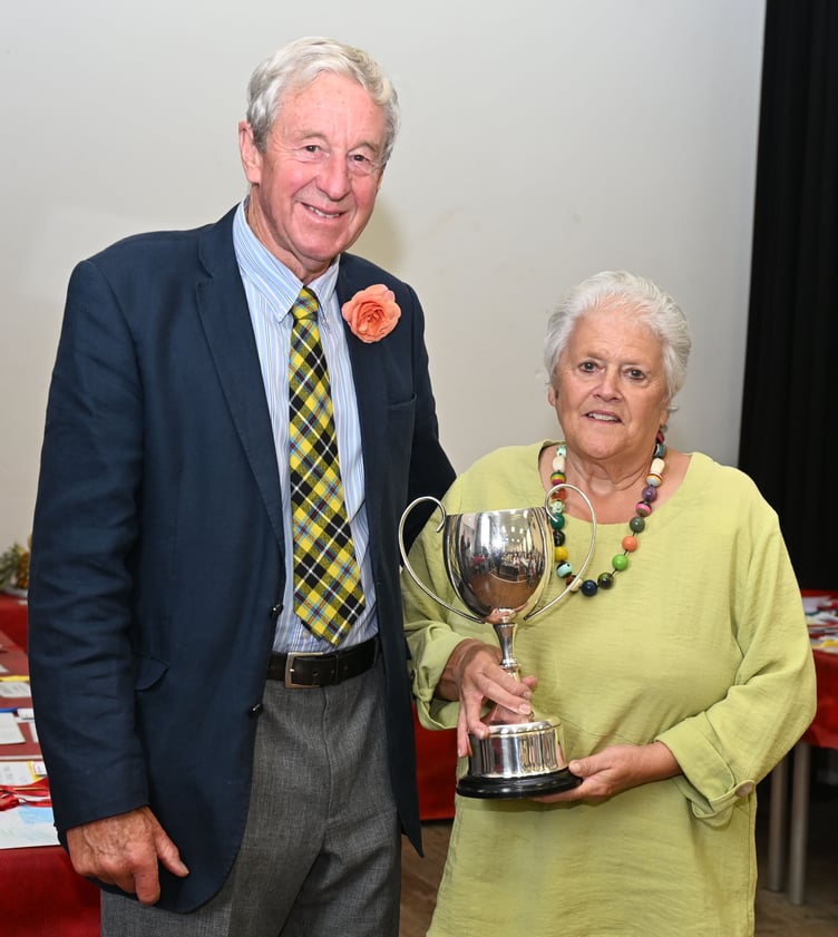 Lorraine Jasper receives the Rendle Memoral trophy from show president Gerald Blewett for most points in the cut flower class (Picture: Adrian Jasper)