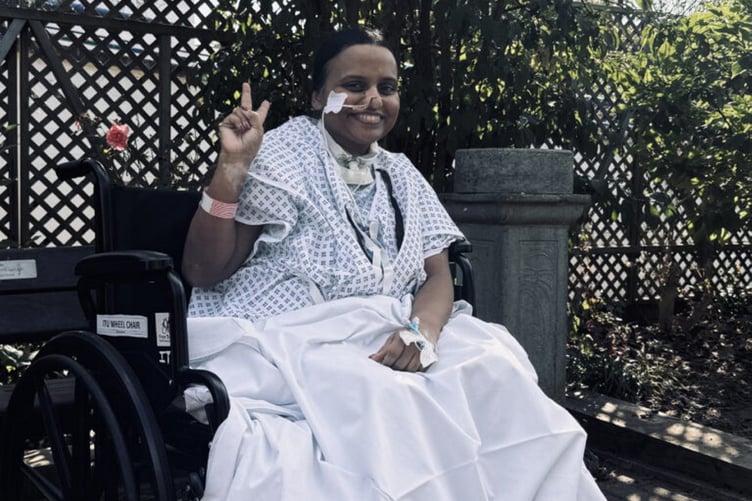 Manju during one of her visits to the St Helier garden while she was in hospital. // A mum whose legs felt "numb" on her flight back to the UK was later hospitalised with a rare neurological condition. Manju Pillai, 46, first started feeling unwell as she returned home from a family holiday in Qatar and the Maldives with her husband Ajith and their kids Ramaya, 23, and Ashaan, 13. She says her legs felt "numb" and "unusually heavy" on the flight back - but she tried to put her symptoms to the back of her mind as she did not want to miss her daughter's graduation celebrations. However, just over a week later, Manjus legs suddenly "stopped working" while she was walking her dog.