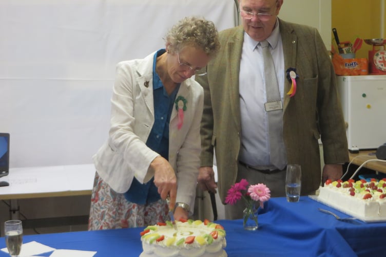 Catherine Crawford, granddaughter of the founders of Woodlarks, cutting the celebration cake