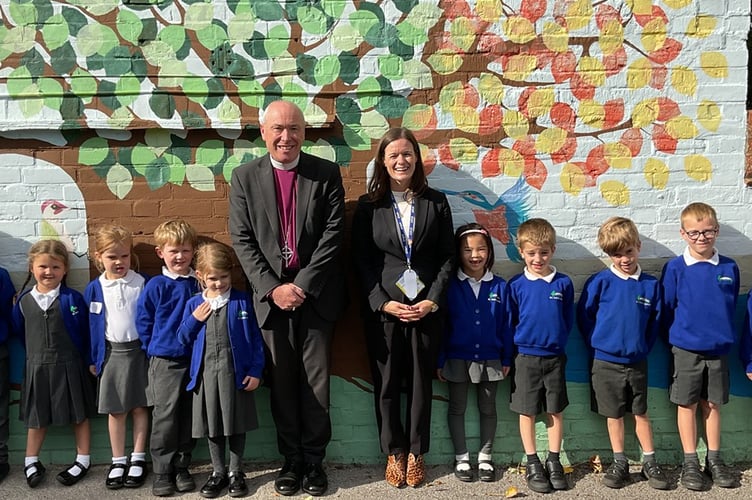 The Rt Revd Paul Davies, Bishop of Dorking, with headteacher Brigid Walters and pupils at All Saints C of E Infant School, Tilford.