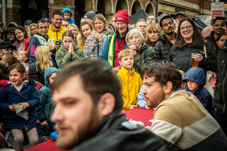 Crowds watch the Farnham Food Festival 2025 chilli-eating contest.