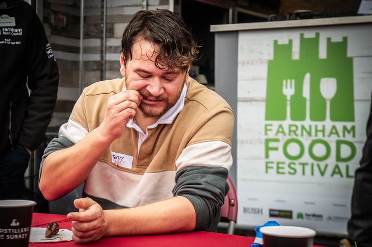 A competitor feels the heat at the Farnham Food Festival 2025 chilli-eating contest.