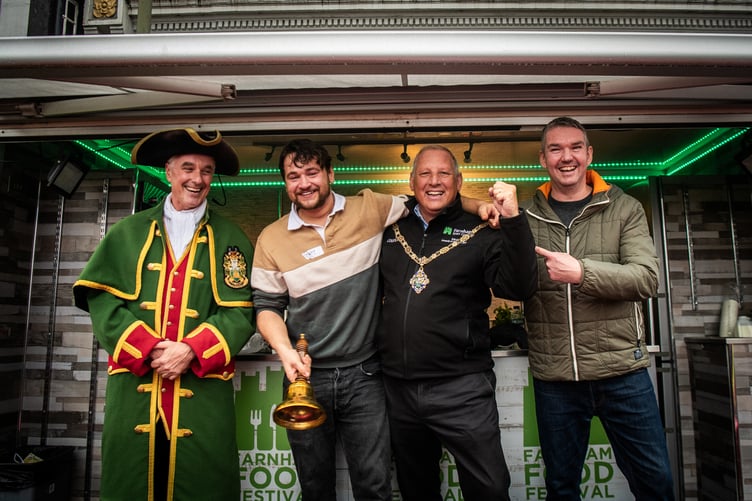 Farnham Town Mayor George Murray congratulates the winner of the Farnham Food and Drink Festival's chilli-eating contest.