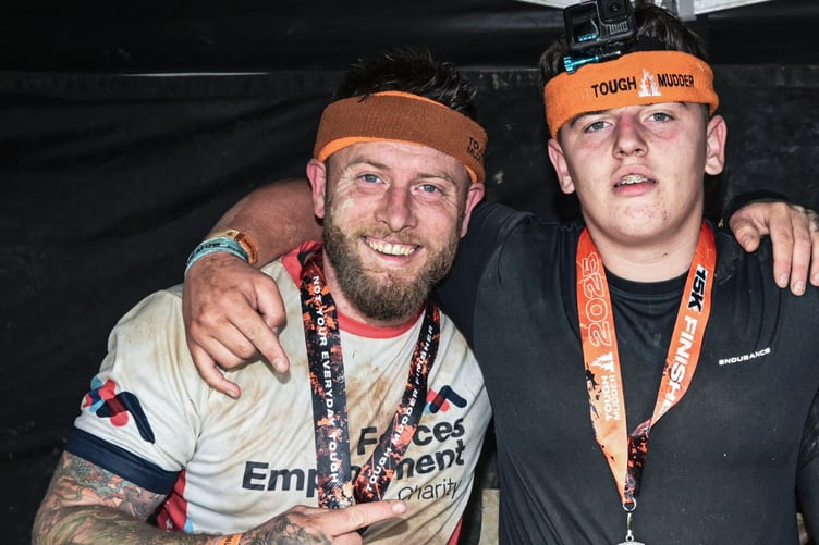 RAF veteran James Shaw and his son Leon on the finish line of a Tough Mudder race.