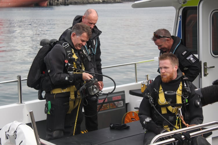 Specialised divers suited up aboard the new police vessel, Neptune.