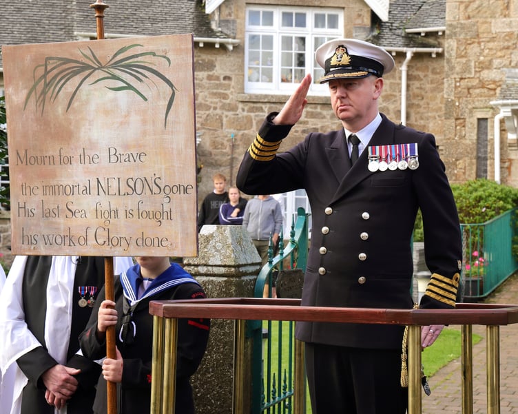 RNAS Captain James Hall takes the salute