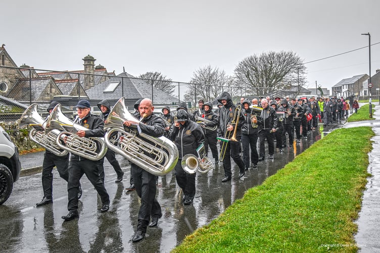 The parade marching to the cemetery in the pouring rain. (Picture: Derek R Williams)