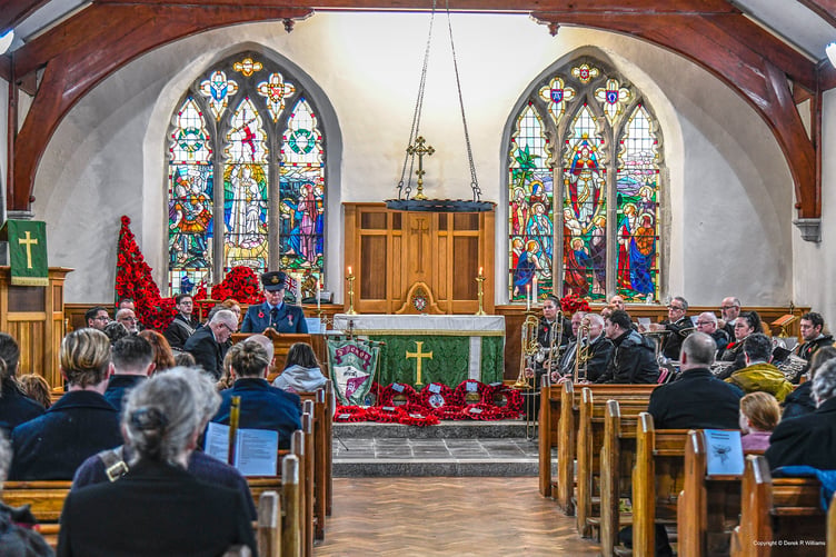 A flight lieutenant from RAF St Mawgan reading the lesson. In the background is a display of knitted poppies. (Picture: Derek R Williams)