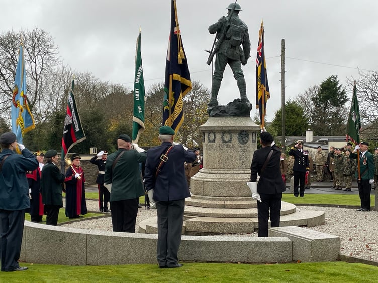Standard bearers raise their standards while veterans salute the memorial at The Keep (Picture: Aaron Greenaway)