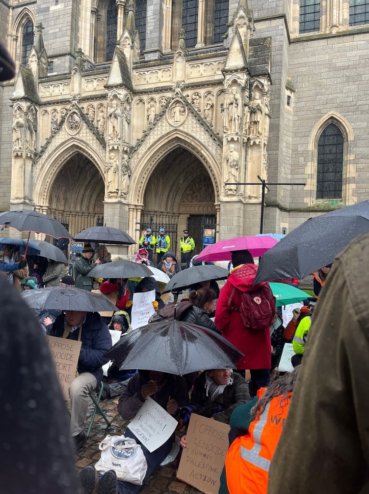 Police watch on from the front entrance of the cathedral