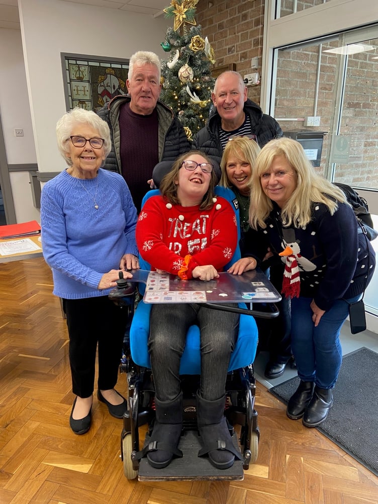 Dame Hannahs resident in festive jumper with family and friends.