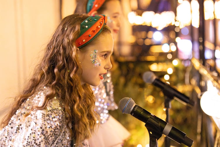Children from Tri.Art Academy sing from the balcony as part of the celebrations.