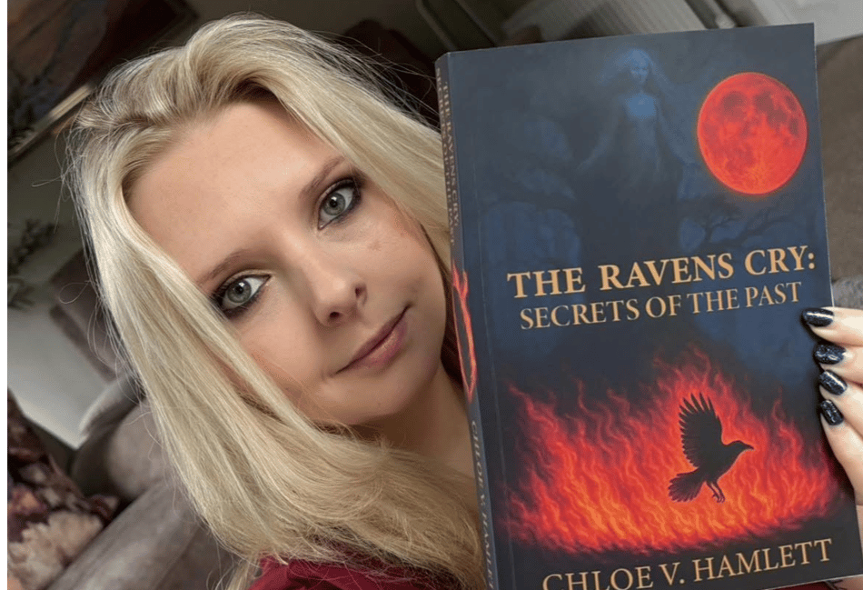<p>Chloe V Hamlett with her book The Raven's Cry</p>