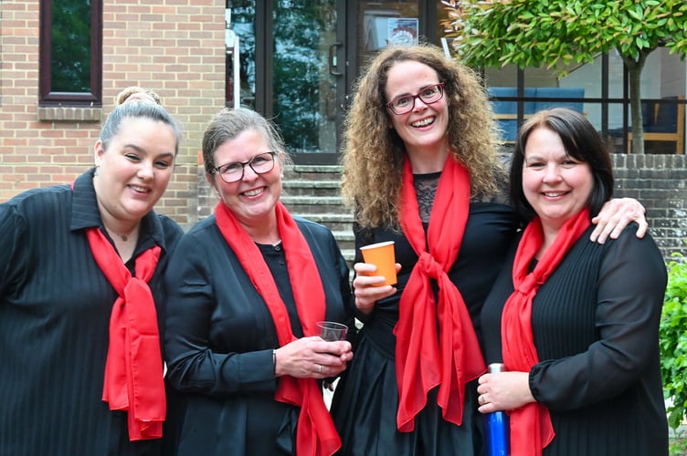 Alresford Community Choir members Kate, Maria, Julia and Sarah tune up for their Christmas concert, November 2025.