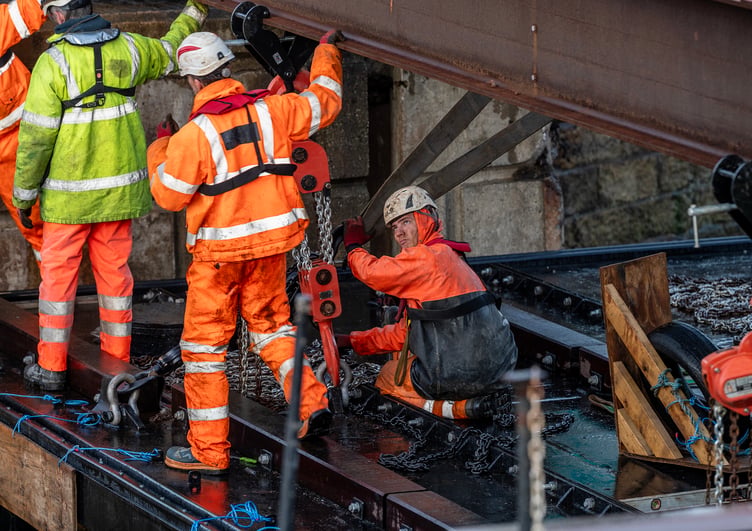 Workers continue lowering new gate into position at Charlestown Harbour