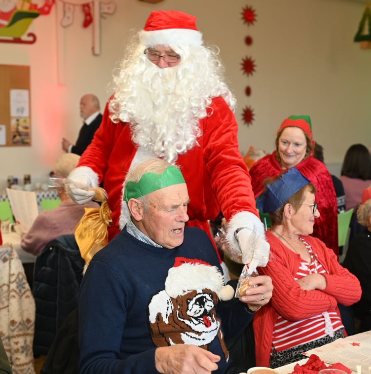 Father Christmas takes some out of his busy schedule to hand out some mince pies at the mayor's Christmas Lunch (Picture: Adrian Jasper)