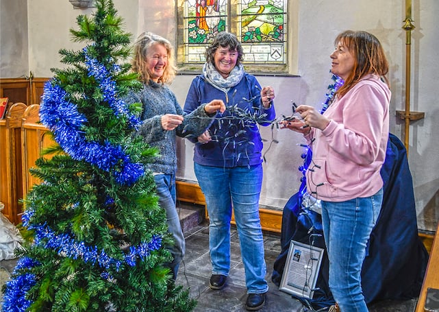 Untangling a string of lights as a tree is decorated. (Picture: Derek R Williams)