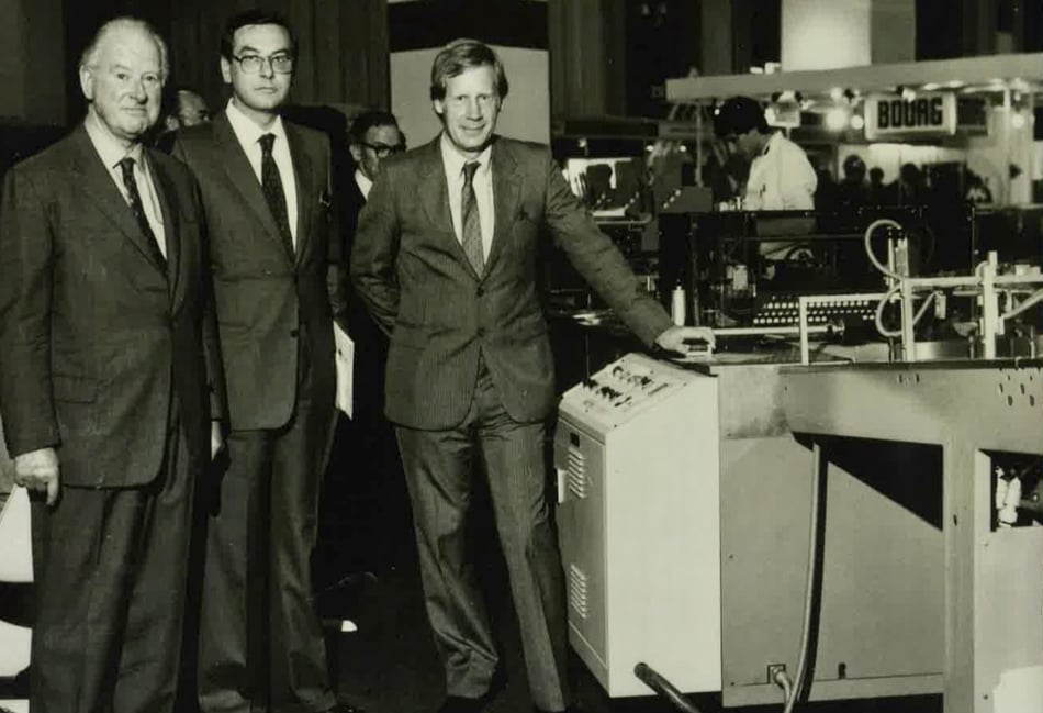 <p>From left: Lt Col A H Buckham, Signor Ballestrazzi of Sitma and Peter Jarrold of Jarrolds Printing at IPEX 1980.</p>