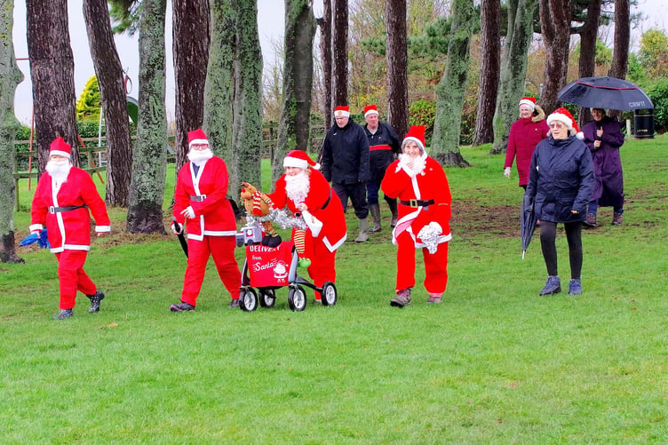 Some ran, and some walked, as they completed a Santa fun run around Watchet War Memorial Recreation Ground. PHOTO: JAG Photo.
