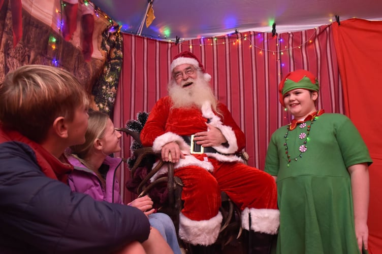 Santa dropped into Dunster Winter Festival and met children in the village's Exmoor National Trust Centre.