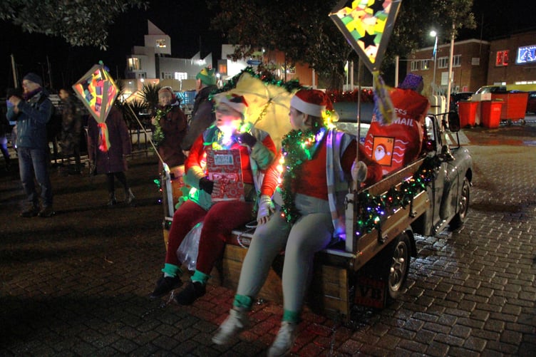 Lighting up the East Quay in Watchet with lanterns for the arrival by boat of Father Christmas. PHOTO: George Ody.