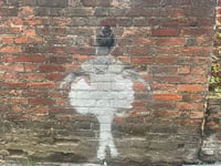 Mystery street artwork appears on wall in Farnham