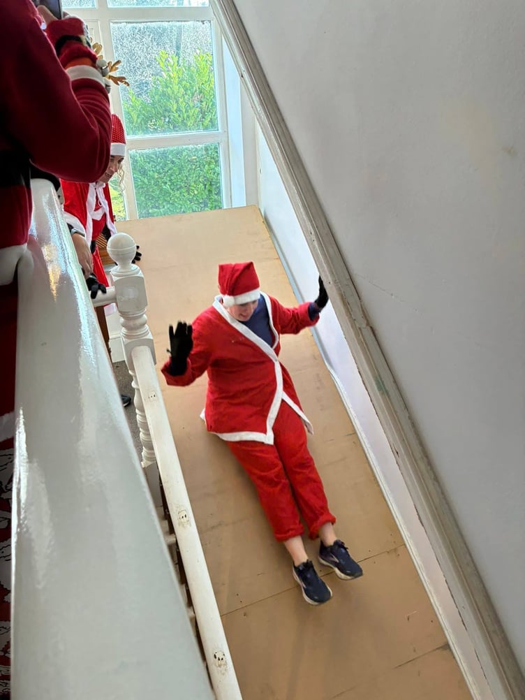 Sliding down the stairs as the festivities get under way (Picture: Matt Allan)
