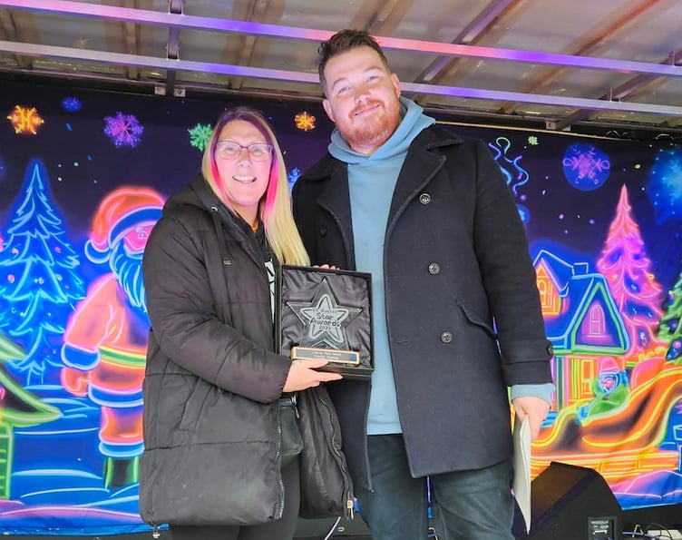 Emma Pearce receives the unsung hero award from Jake Richards.