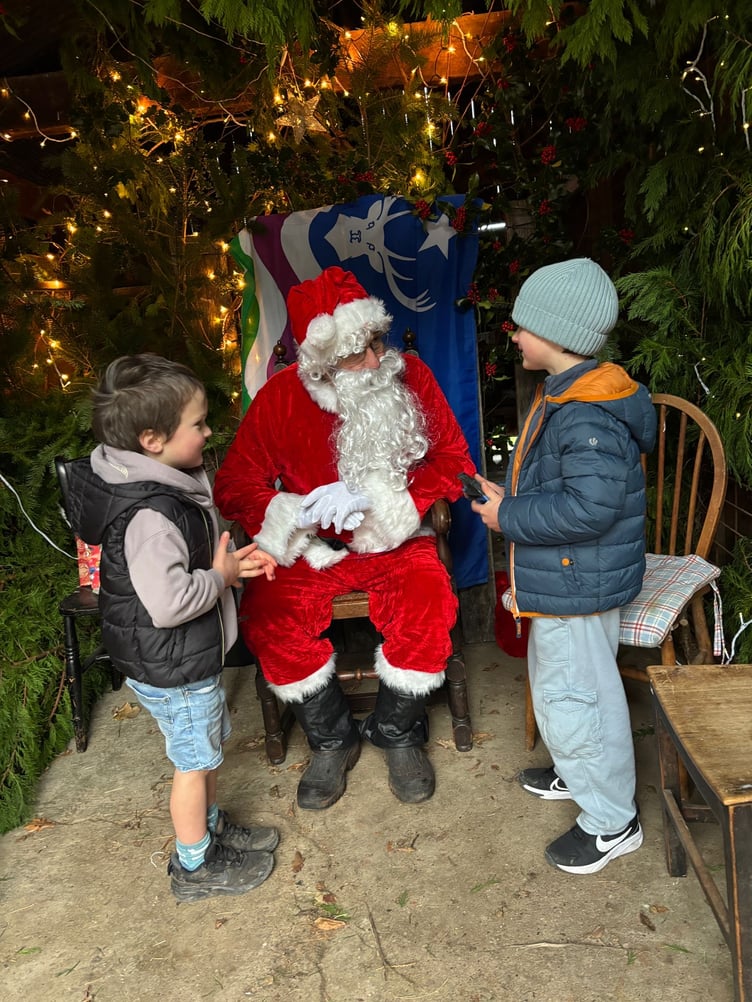 Children meet Father Christmas in his Porlock Weir grotto.