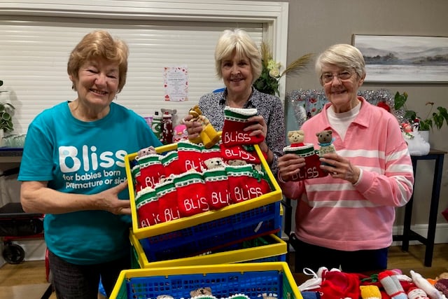Dianne Bennet, left, packing stockings with volunteers Susan and Margaret.