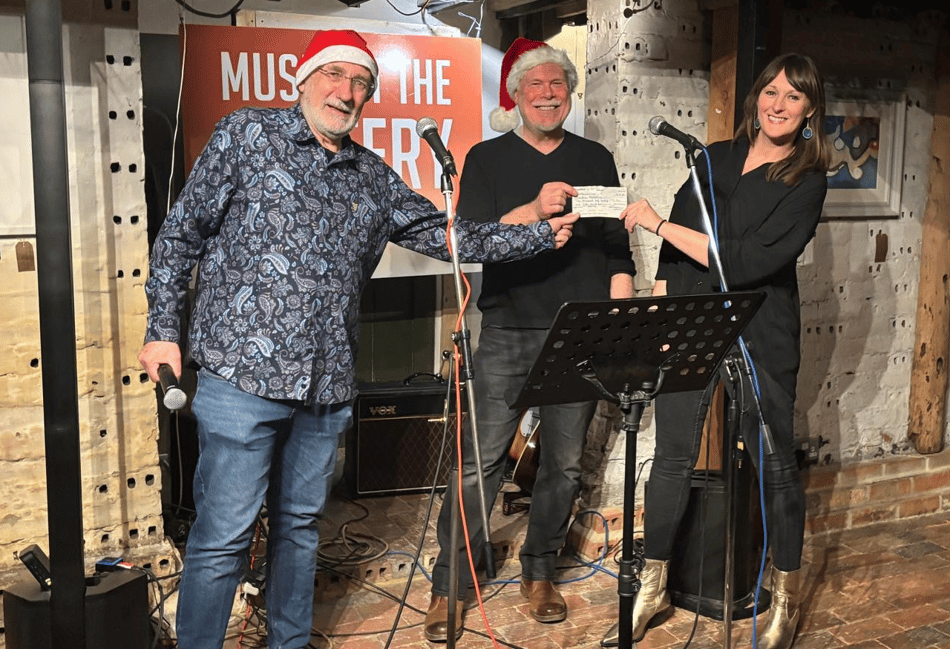 <p>Music At The Pottery organisers Peter Crutchfield and Jim Cozens present a cheque for £2,150 to Kathryn McManus, chief executive of Creative Response</p>