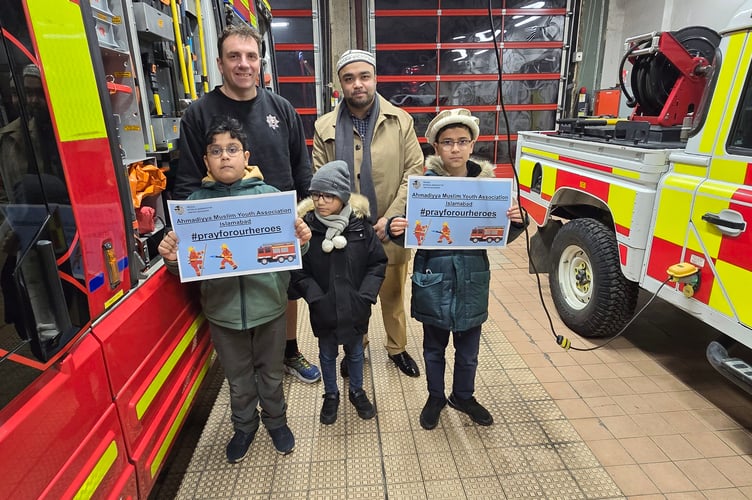 Members of the Ahmadiyya Muslim Youth Association during a New Year’s Eve visit to Farnham firefighters to deliver food and show their appreciation.