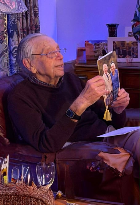 Farnham solicitor and Redgrave Theatre supporter John Draper opens a card from the King and Queen to mark his 100th birthday.
