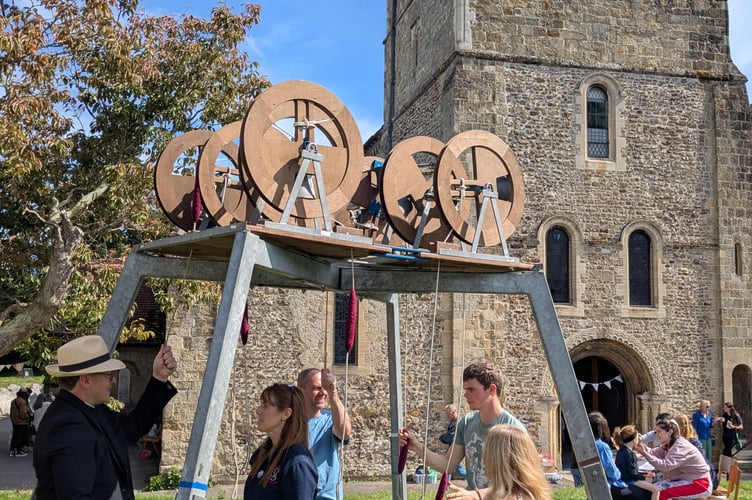 Mini ring at St Peter's Church Fete, Petersfield, summer 2025. Revd Will Hughes receives guidance from Rachael Barber. The other ringers are Jason Wedley, James Wedley and Rebecca Restall.
