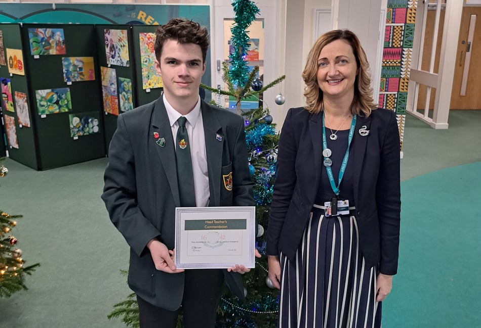 <p>Life-saving pupil Jack Palmer receives a certificate commemorating his efforts from Eggar's School headteacher Sarah Holman.</p>