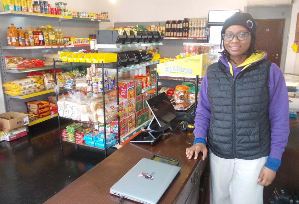 <p>Kemi Adegboyega behind the counter at Africstore Alton: The Continental.</p>