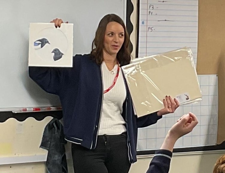 Showing Minehead Middle School pupils some of her work is self-employed artist Hannah Norman.
