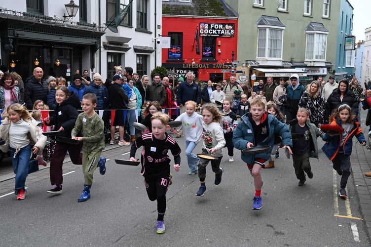 The determination on the children’s faces may reflect the concentration required to toss the pancake every 10 metres during the dash!