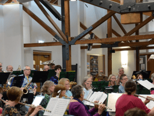 Audience gives great thanks for music of band and choir