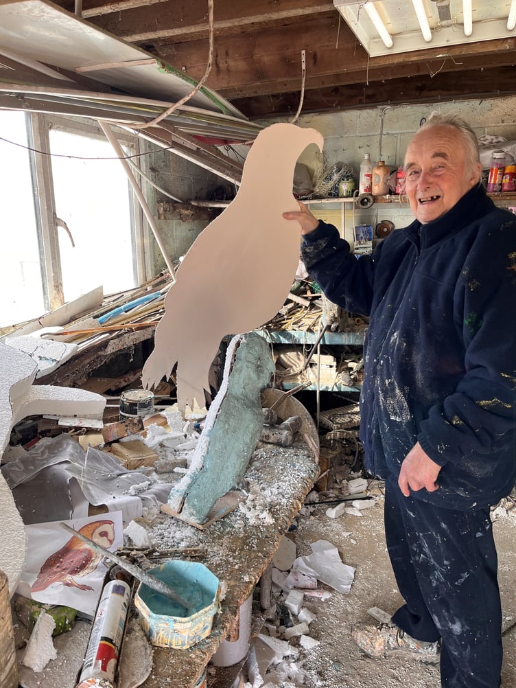 Malcolm Curley with the wooden core of a bird sculpture.