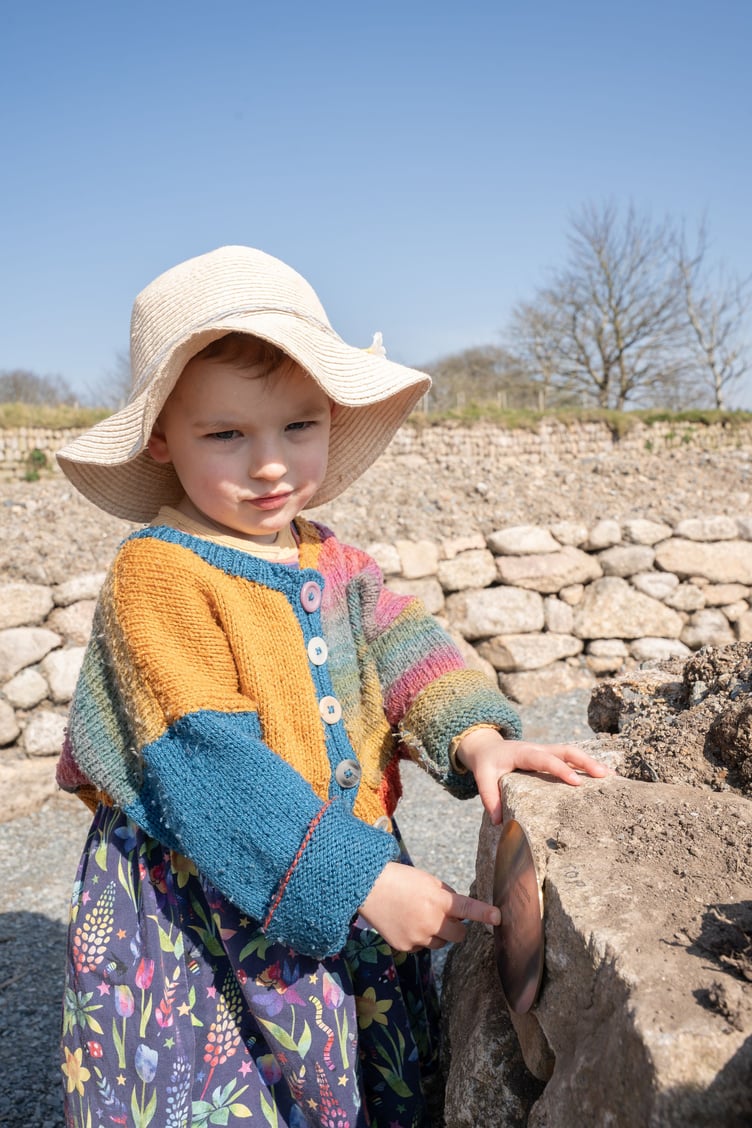Three-year-old Bryher Tagney lays the last stone at Kerdroya