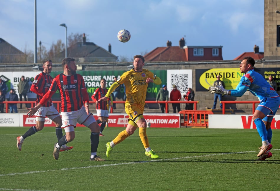 <p>Aldershot Town's James Henry looks for an opening against Morecambe (Photo: Ian Morsman)</p>